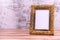 Picture frame on wall background and wooden table. Poster product design styled