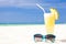 Picture of fresh banana and pineapple juice and sunglasses on tropical beach