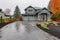 picture of a grey stone driveway leading to a craftsman house