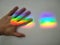 picture of hand on rainbow stripe on wall means seize beautiful dreams