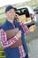 Picture happy deliveryman holding box and cellphone