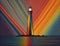 Picture illustrating a lighthouse emanating rainbow light, embodying concepts of hope, joy, and diversity