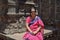 Picture of Indian lady seating at ancient temple and wearing traditional cloths