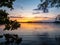 Picture of Lakeside Sunset with trees and blue sky