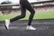 Picture of the legs only. Girl running on the track in the stadium at daytime