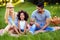 Picture of lovely couple with their daughter having picnic