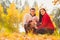 Picture of lovely family in autumn park, young parents with nice adorable kids playing outdoors, five cheerful person have fun on