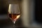 Picture in low key of glass of rose wine with reflection of old stone traditional provencal house in it. Rose wine in Provence,