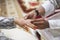 Picture of man putting wedding ring on woman hand.