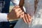 Picture of man and woman with wedding ring.Young married couple holding hands, ceremony wedding day. Newly wed couple`s hands wit