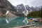 A picture of Moraine lake and ten peaks with boats.