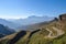 picture of mountain range, with winding road and clear blue sky in the background