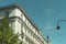 Picture of a nice historic building in the middle on the street with green tree in sunny day