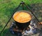 Picture of an omelet with tomatoes  in a big boiler in outdoors