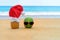 Picture of  pineapple wearing Santa Claus hat and green cheerful watermelon in  sunglasses on the tropical beach. New Year and