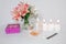 Picture of a pink luxury gift box with a bouquet of beautiful Alstroemeria flowers, a romantic candle, perfume and a credit card.