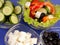 Picture of plates with greek salad and ingridients