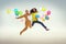 Picture presenting two funny guys jumping and holding balloons