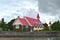 Picture of a red church located close to a beach, very famous touristic place within Mauritius Island.