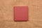 Picture of red leather photo album cover on jute background. Keeping memories alive throughout the years