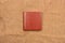 Picture of reddish brown leather photo album cover on jute background. Keeping memories alive throughout the years