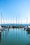 Picture of row of luxury sailboats reflected in water, yacht port on the bay, water transport, ocean transportation, beautiful