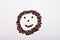 Picture of smiley face made of coffee beans on white backgroun