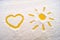 Picture in the snow, heart and yellow shining sun