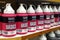 Picture of a store shelf full of bottles of Liquitex red paint,