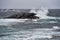 Picture of strong waves hitting a big rock on the coast of the Norwegian Sea