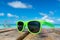 Picture of sunglasses on the tropical beach, vacation. Traveler