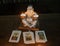 Picture taken to a tarot deck with a Buddha with candles.