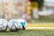 Picture of three soccer balls on field