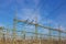 Picture of a transformer station with many insulators and cables during the day