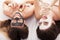 A picture of two girls friends relaxing with facial masks on over white background