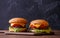 Picture of two hamburgers on wooden table