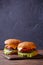 Picture of two hamburgers on wooden table