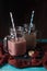 Picture of two jugs with milkshake with straw