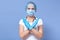 Picture of woman wearing medical protection mask, medical hat and rubber gloves, crossing hands to stop virus, epidemy, world