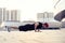 Picture of a young athletic man doing push ups outdoors.Fitness and exercising outdoors urban environment.