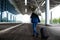 Picture of young businessman holding suitcase and umbrella at rainy airport