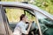 Picture of young businesswoman speaks by phone and doing makeup while driving a car in the traffic jam