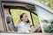 Picture of young businesswoman speaks by phone and doing makeup while driving a car in the traffic jam