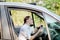 Picture of young businesswoman speaks by phone and doing makeup while driving a car in the traffic jam