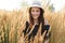 Picture of young woman in hat in wheat field