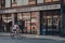 Picturehouse Cinema and cafe in Crouch End, London, UK, man cycling past, motion blur