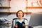 Pictures of an Asian woman smiling and reading in her room.