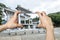 Pictures on mobile smart phone in Front View of Tian Tan Giant Buddha in blue sky