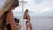 Pictures phone of girl in bathing suit on coast sea, photo of long-haired women on smartphone in background of water,