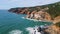 Picturesque aerial rugged seashore washing by powerful ocean in slow motion.